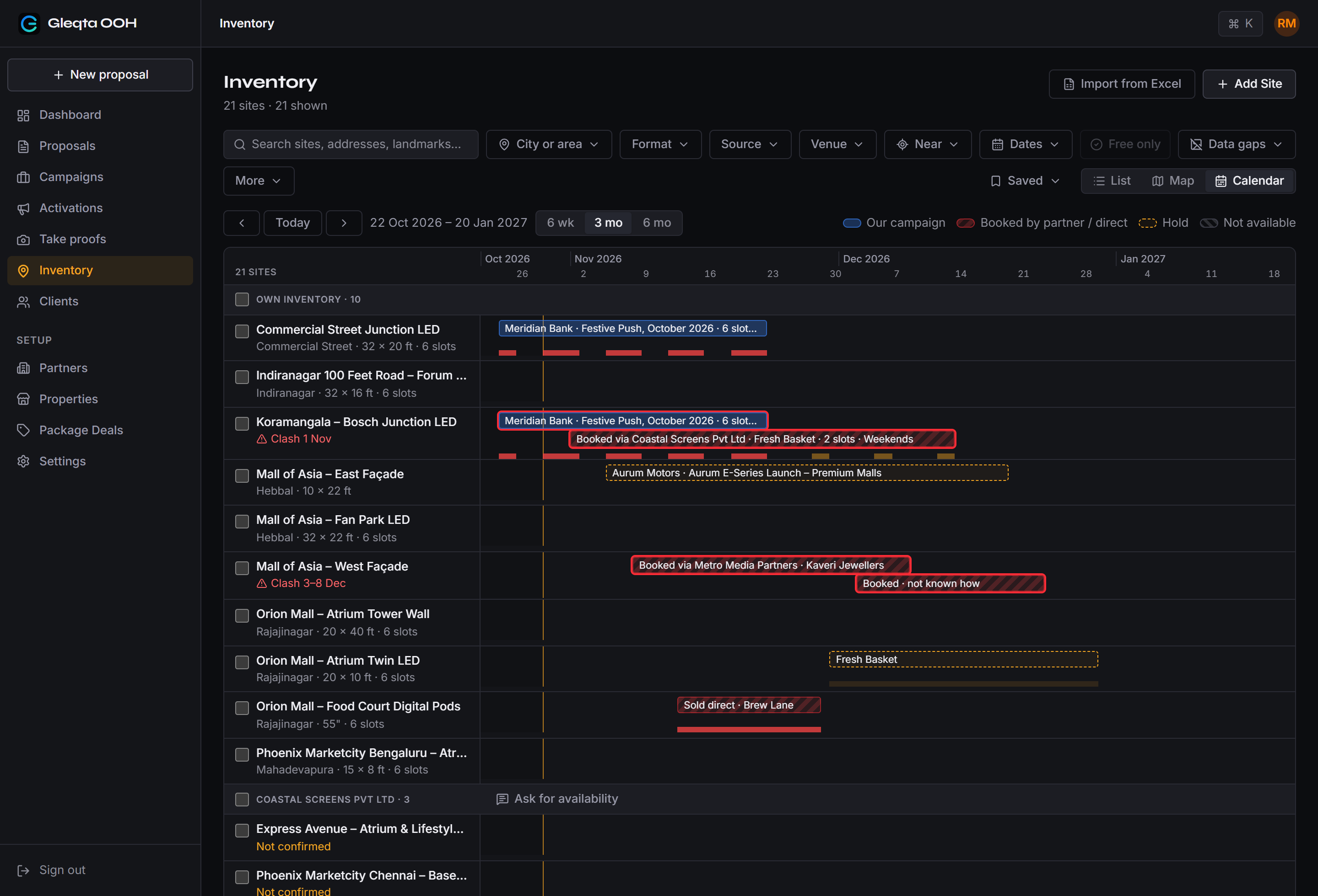 The Inventory Calendar in Gleqta: own and partner sites down the side and three months across, with campaigns, bookings made via partners, sold-direct bookings and holds marked on each site, and two clashes called out.